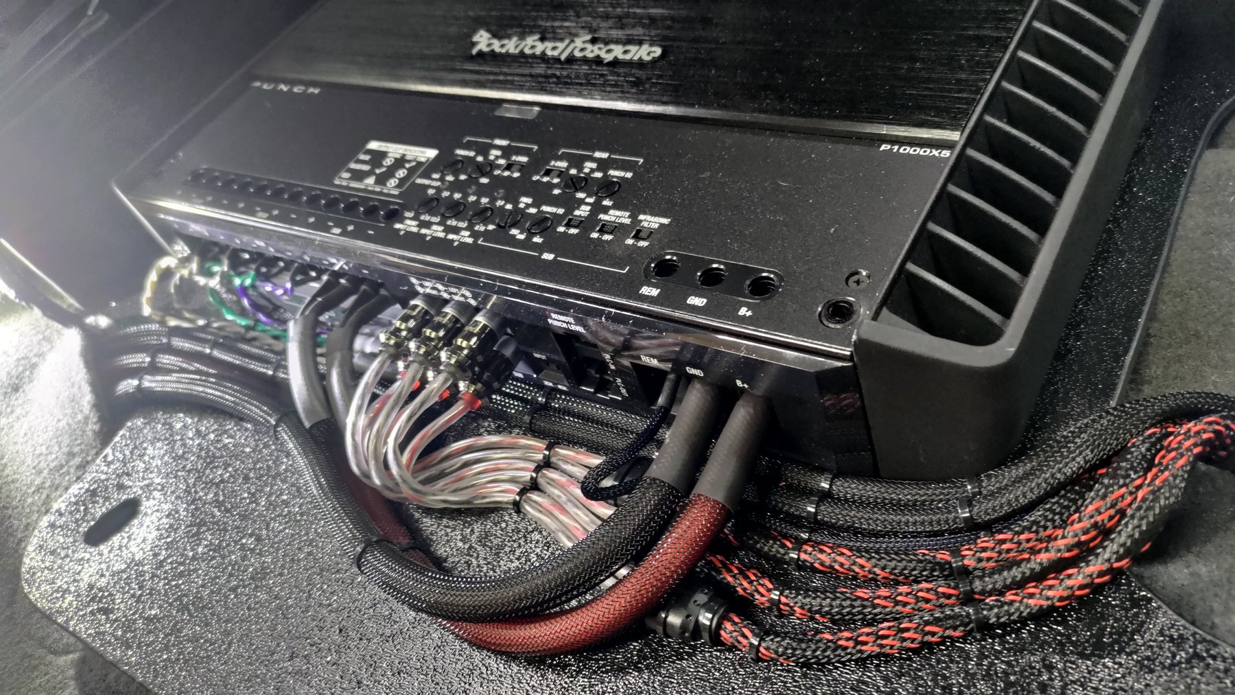 Braided cable runs and speaker-wire connections at an amplifier