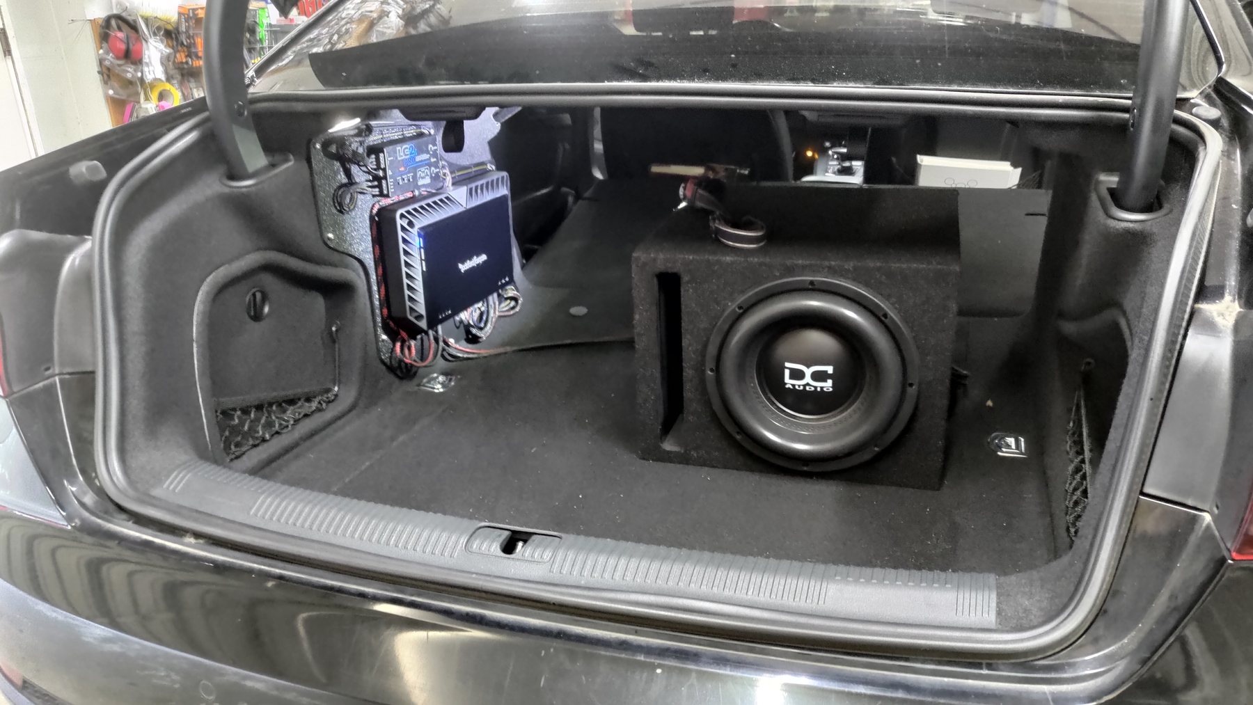 Subwoofer enclosure and amplifier rack installed in an Audi cargo area