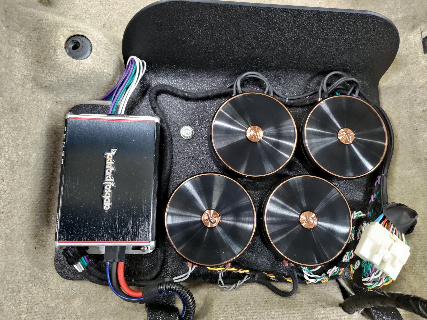 Four passive crossover assemblies and an amplifier arranged on a shaped mounting panel