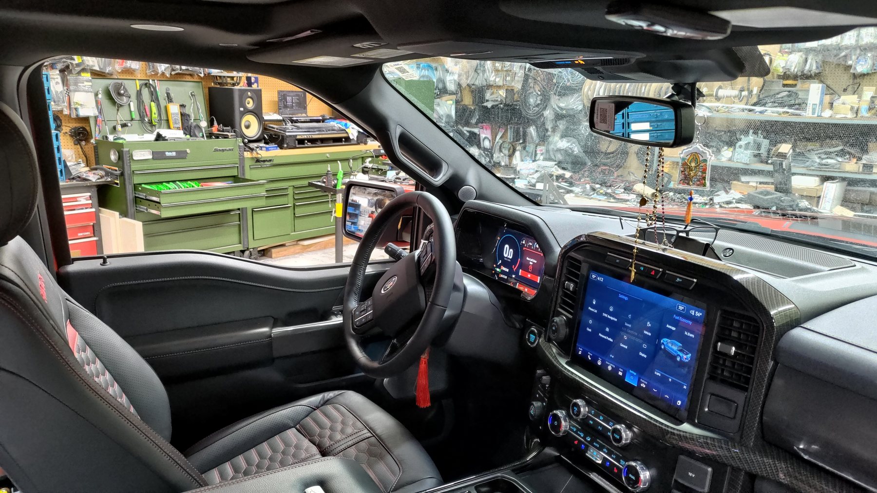 Truck interior with dashboard screen and factory-style controls
